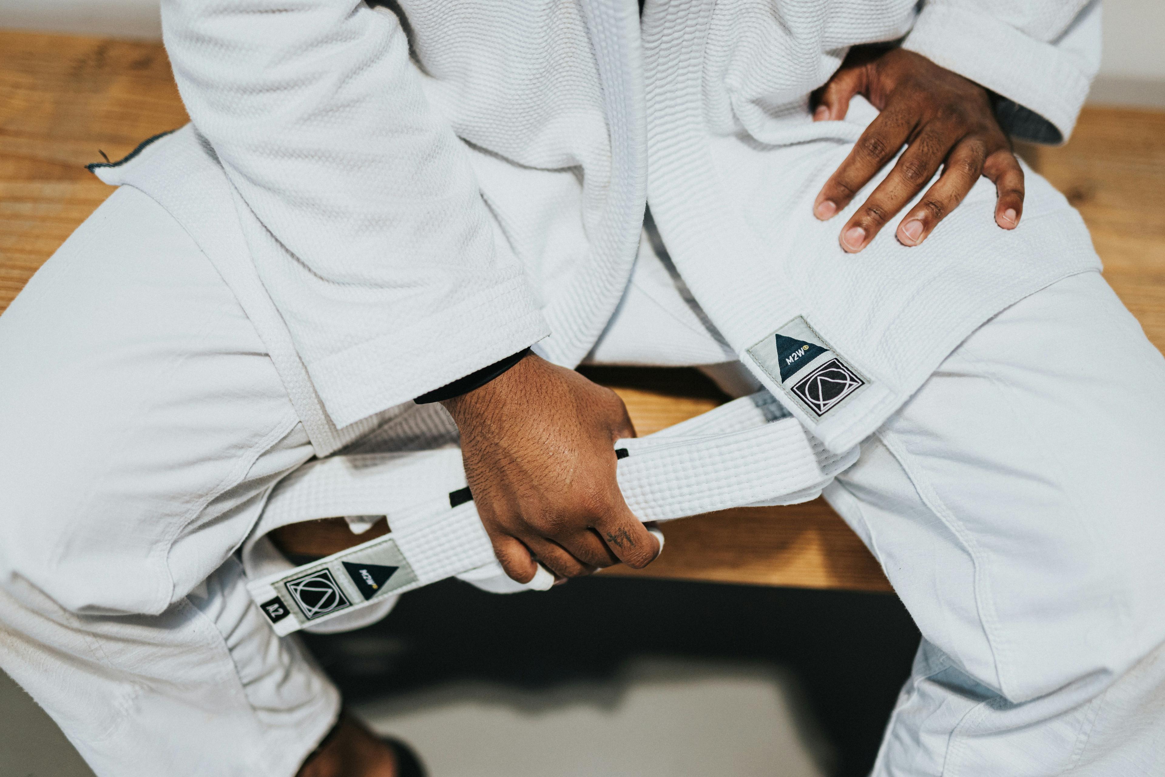 Man holding a white belt.